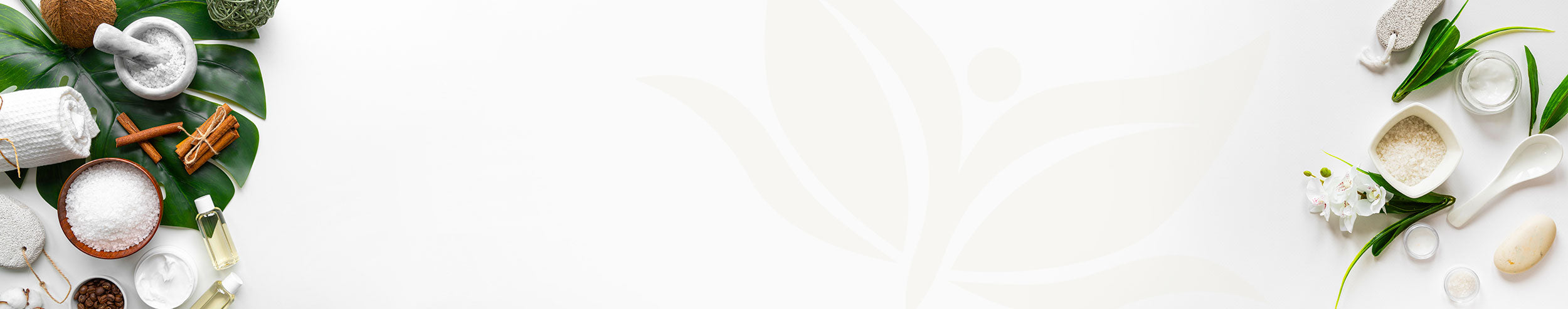 A plain white image with a selection of foliage and spa treatment supplies around the edges